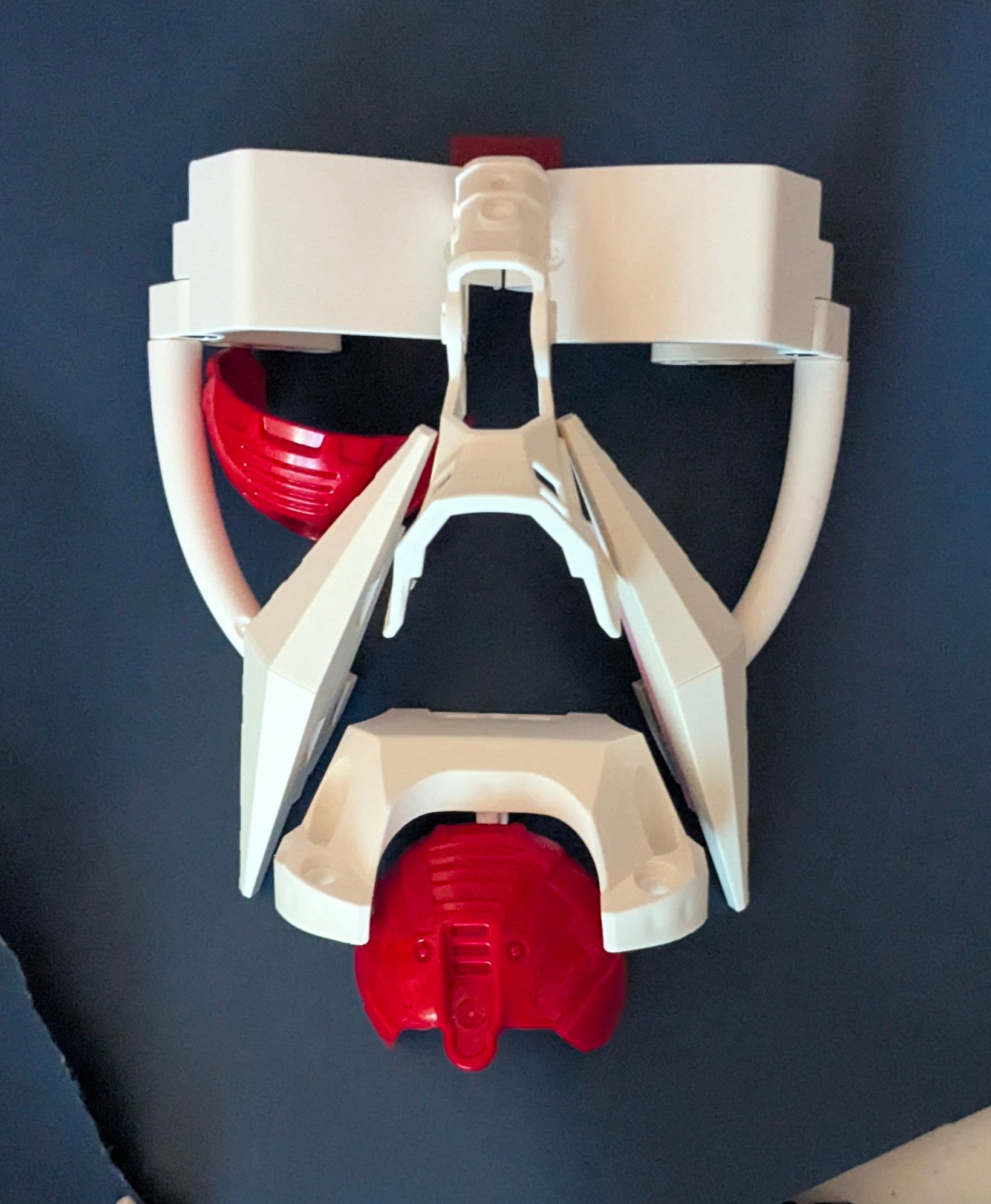 White angular elements outline a face’s brow, cheek, and jaw