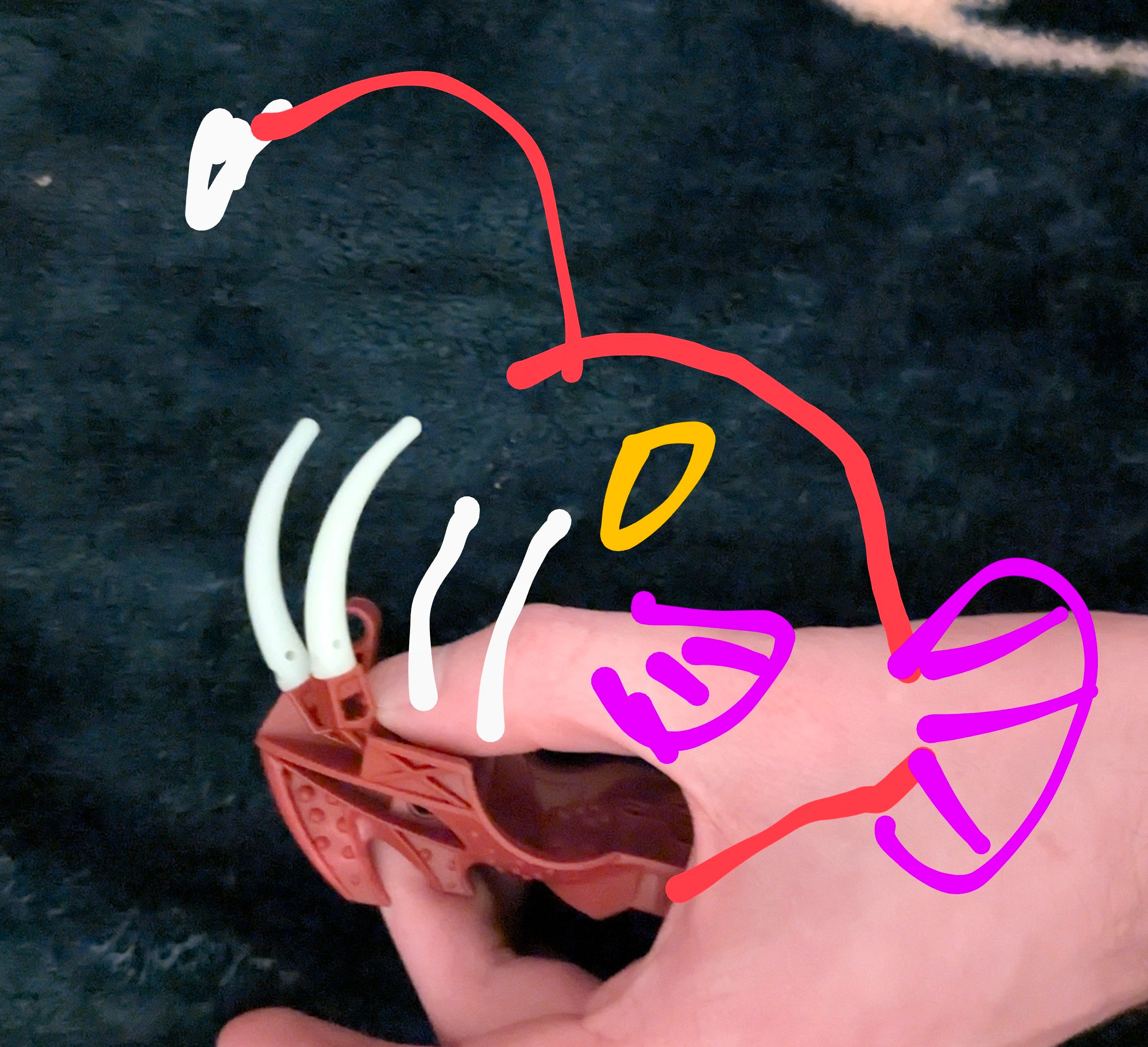 Lego elements forming jaw and teeth with sketch of angerfish overlaid
