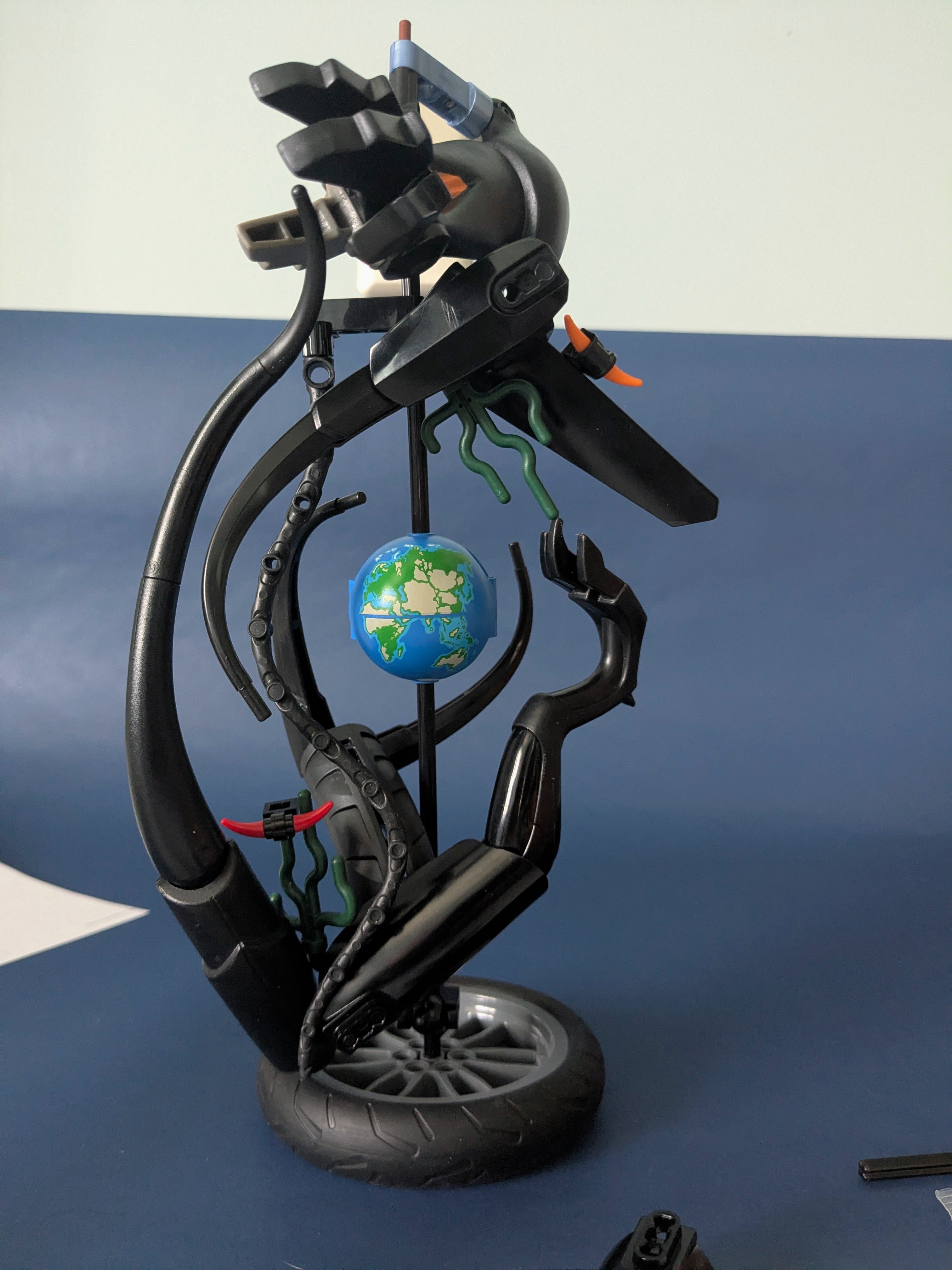 Several tendrils mounted on a stand with Earth in the middle