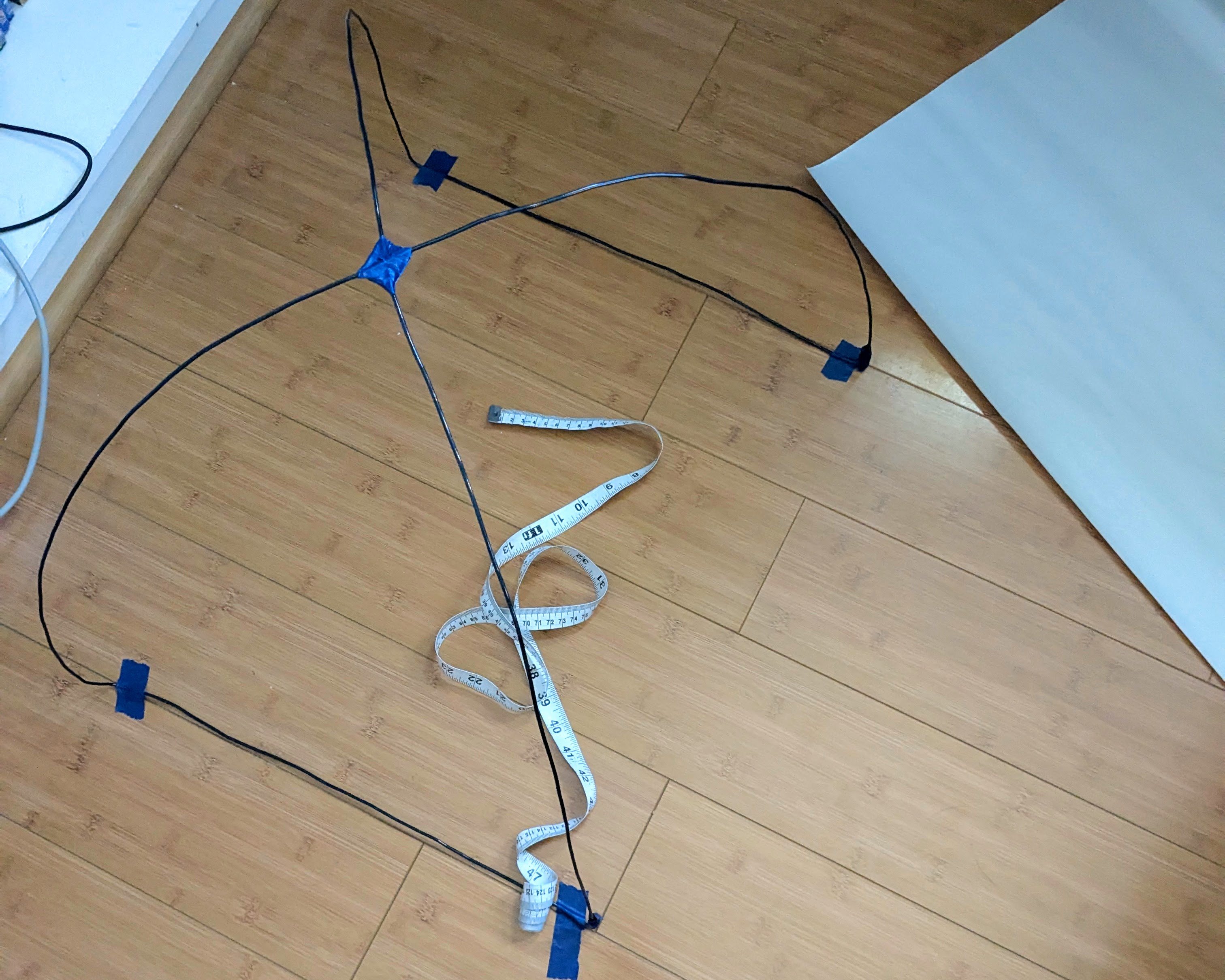 Two arches of wire crossing at 90 degree angle, connected to form a tent shape with square base