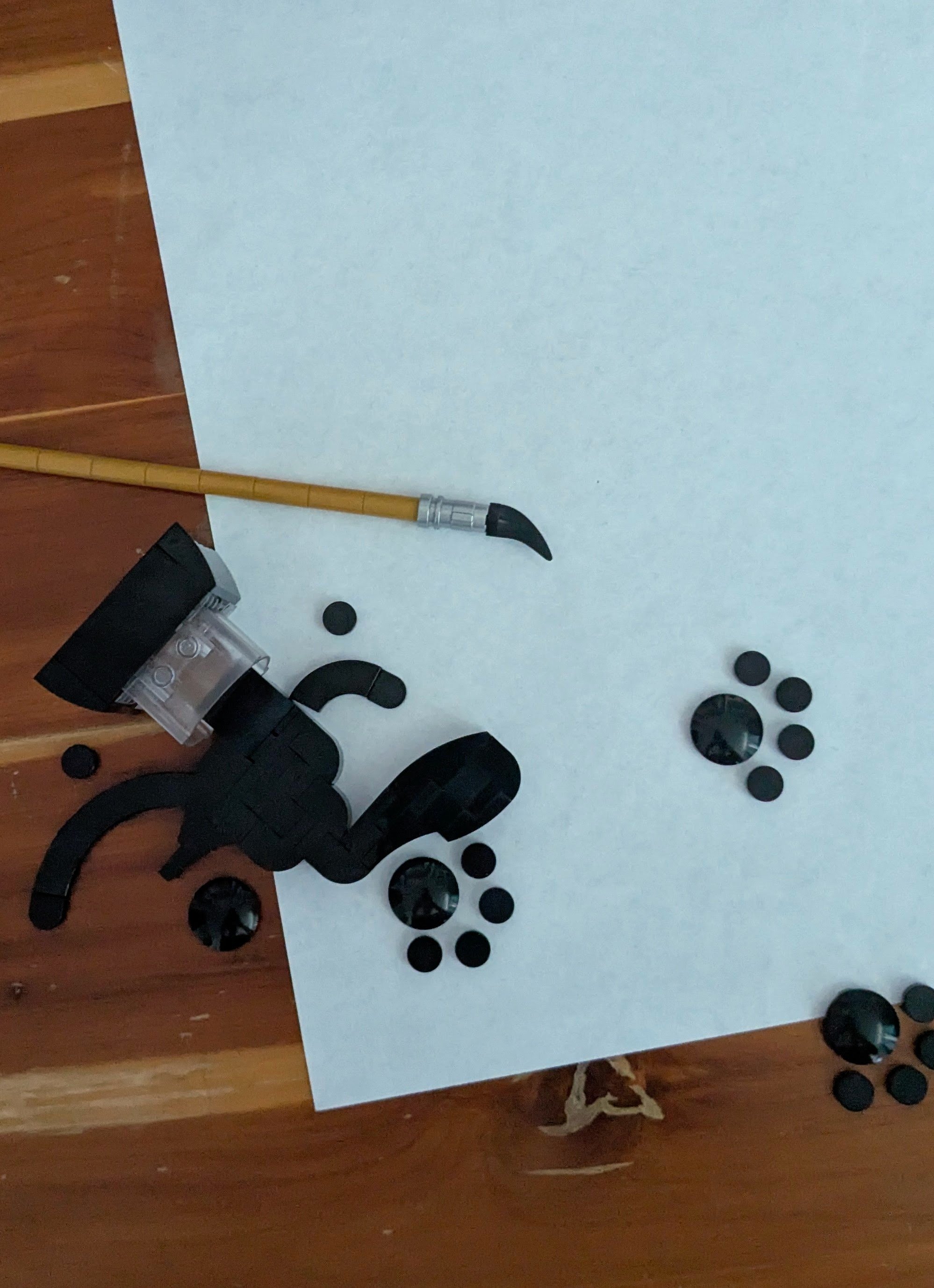 Slight shadows around small tiles; reflections on round elements show distorted view of room and photographer