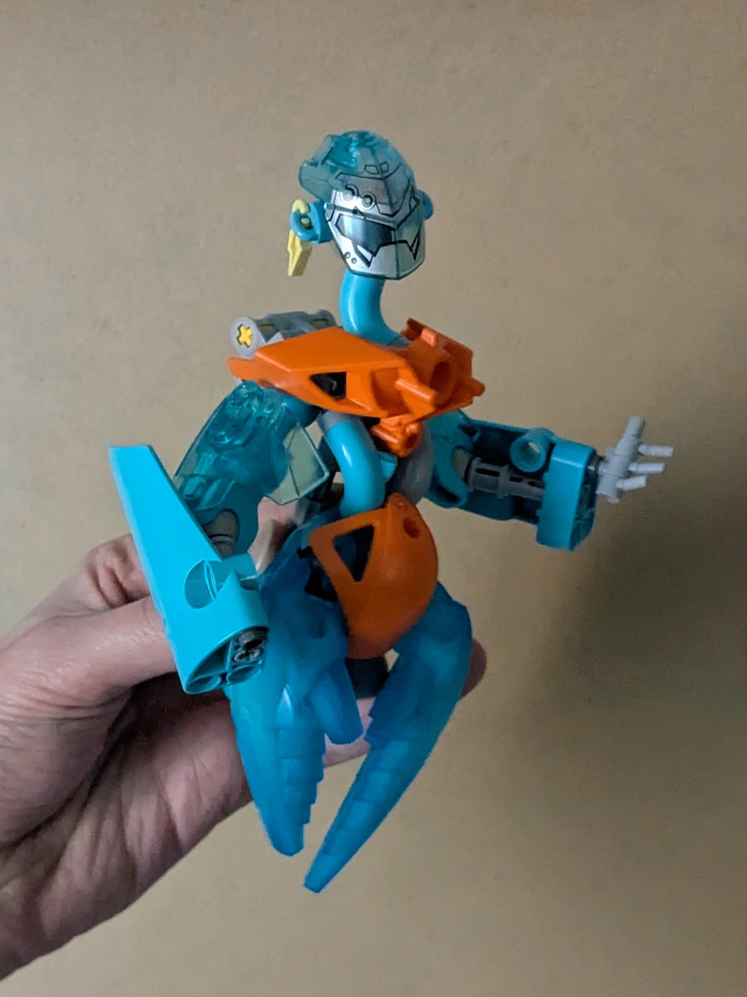 Figure with transparent blue smoke-like hips; blues replace all green and some orange elements, leaving only orange accents like cloth at the shoulder and waist