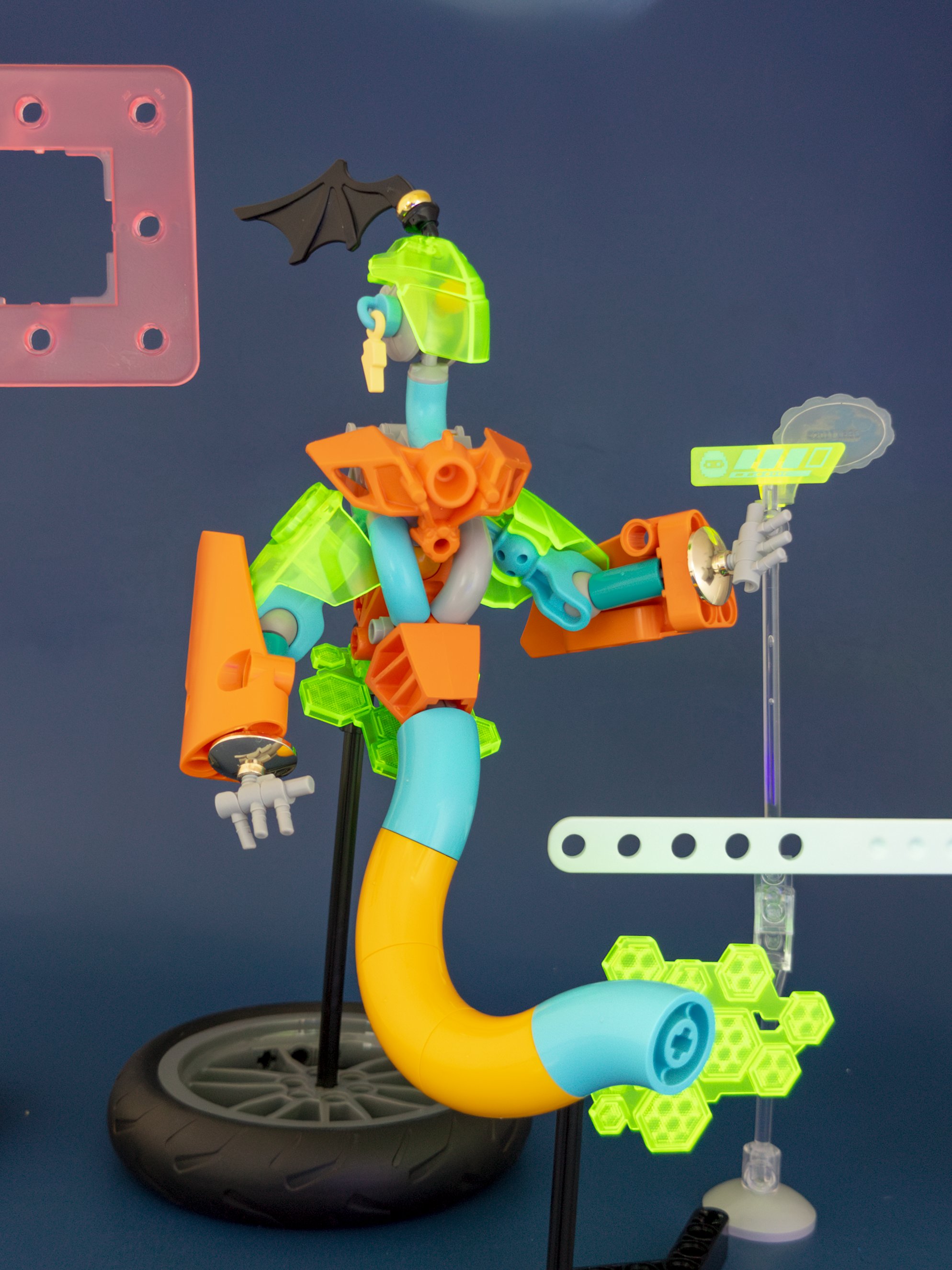 Figure against dark blue cardstock; transparent elements glow brightly and simple stands support the