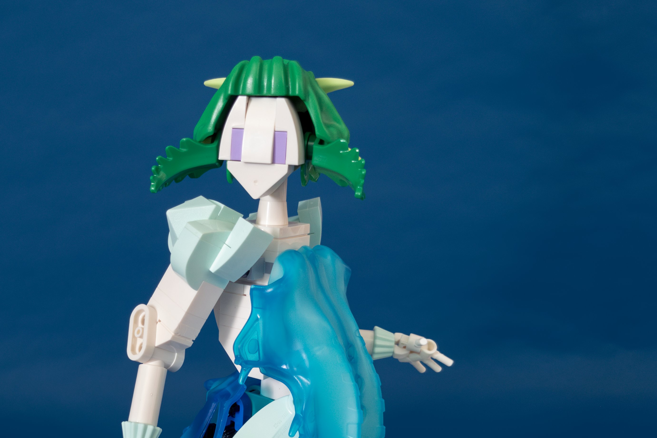 Closeup on figure’s face, showing her hair afloat in the tide